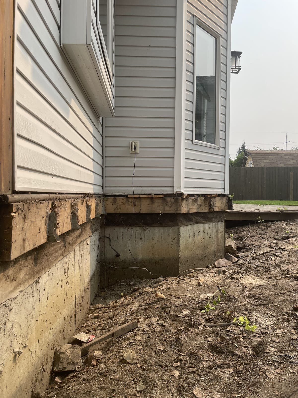Soil dug back from a house foundation wall ready for drainage rock