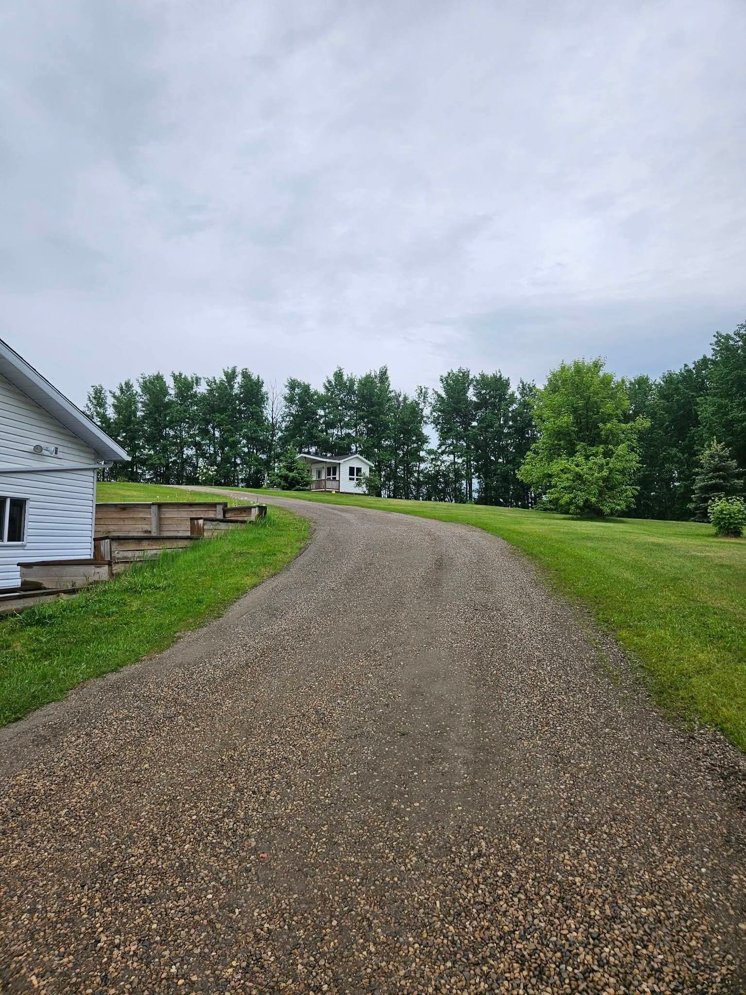 The same driveway rebuilt with smooth, freshly graded gravel