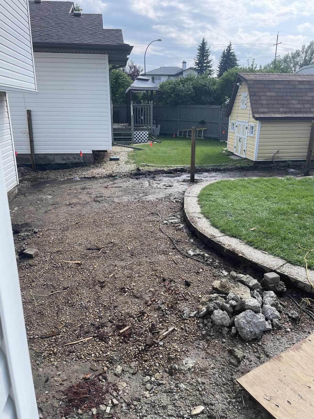 Side yard stripped back with old broken concrete piled ready to be hauled away