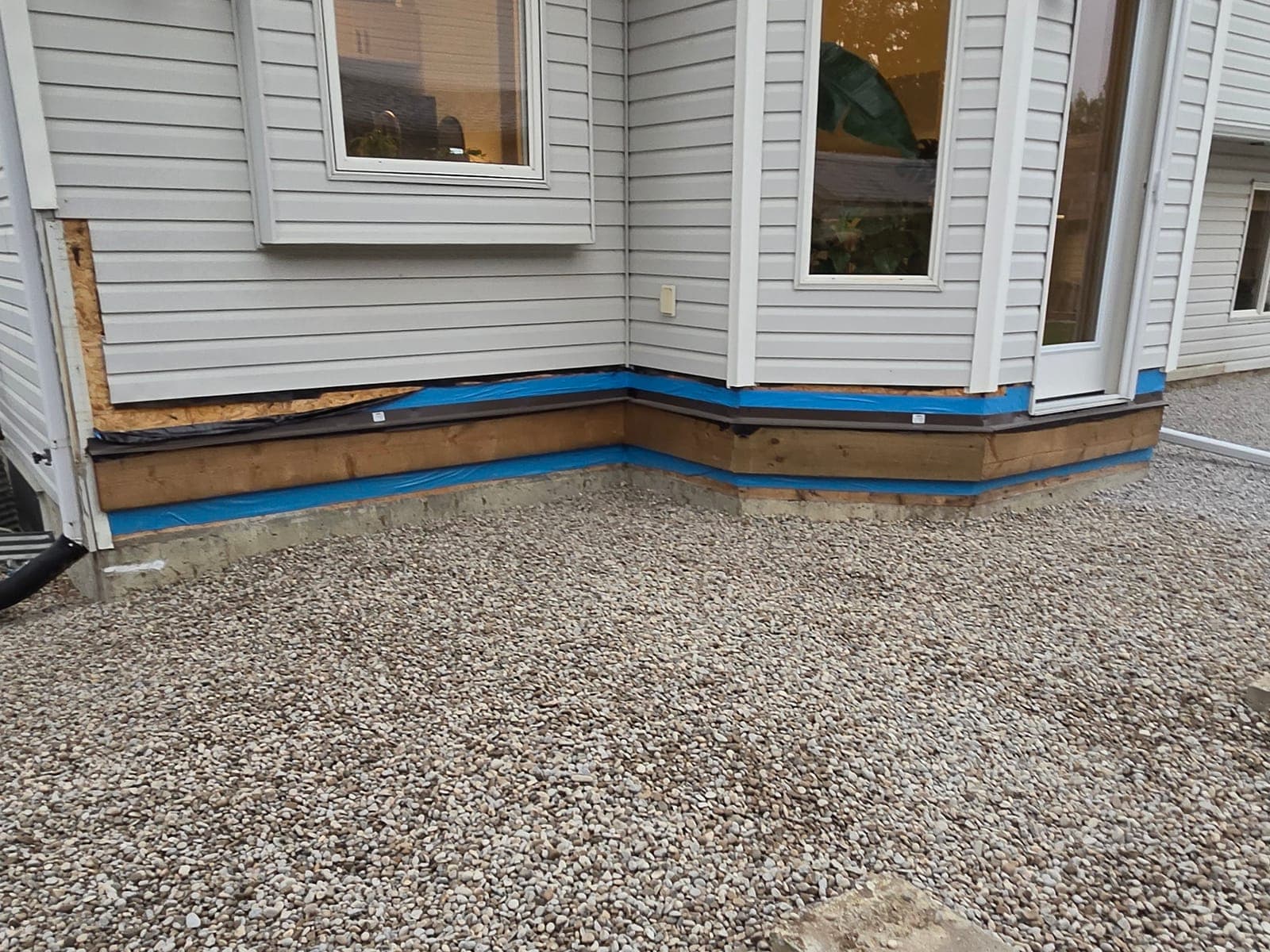 The same foundation corner backfilled with clean washed drainage rock