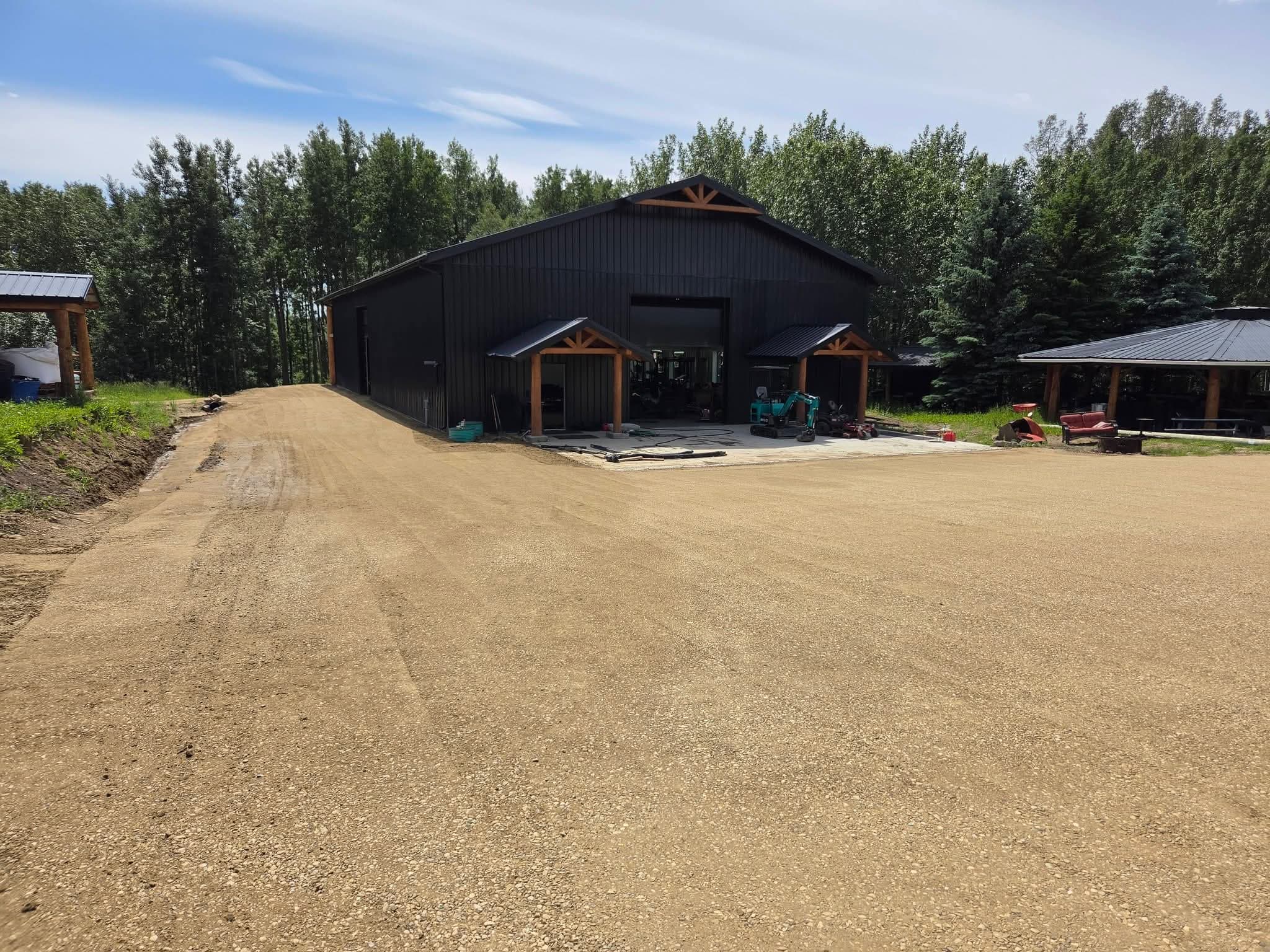 Finished gravel driveway and parking area alongside the shop